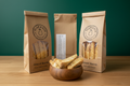 Almond biscotti bags with wooden bowl on wooden surface with forest green wall